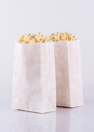 Popcorn in paper bags isolated on white backgroundの写真素材