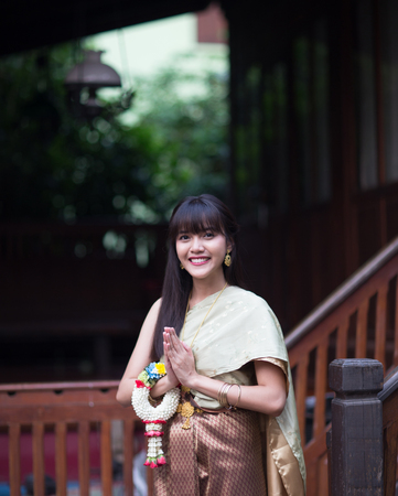 Nice and beautiful smiling Thai girl with Thai ancient style dressing の写真素材