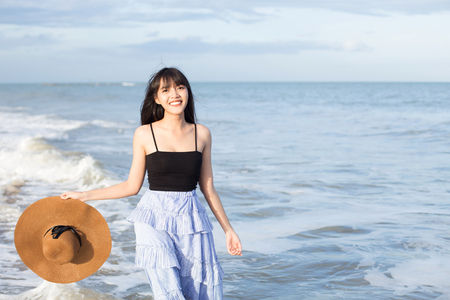 Young girl enjoy and happy her relaxing on the beach, Hua Hin, Thailandの写真素材