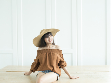 Young beautiful girl smiling and relaxing in front of the backgroundの写真素材