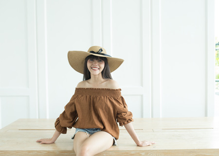 Young beautiful girl smiling and relaxing in front of the backgroundの写真素材