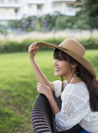 Young beautiful girl happy and relaxing on the armchair, Hua Hin, Thailandの写真素材