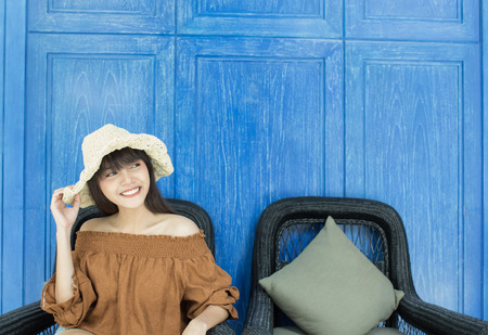 Young beautiful girl happy and relaxing on the armchair, Hua Hin, Thailandの写真素材