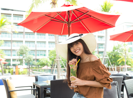 Young girl smile enjoy and happy to drinking her cocktailの写真素材