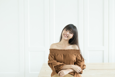 Young beautiful girl smiling and relaxing in front of the backgroundの写真素材