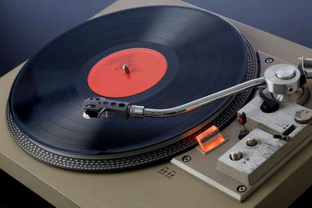 Retro record player spinning with needle approaching the record  の写真素材