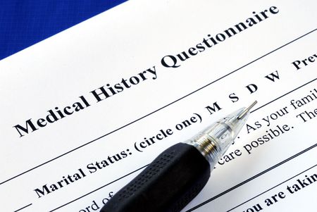 File the medical history questionnaire with a pencilの写真素材