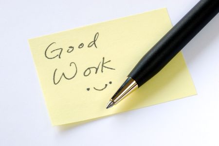 Write the words Good Work on a yellow sticky noteの写真素材