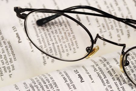 A pair of glasses on a book concepts of knowledge and educationの写真素材