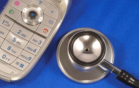 A stethoscope with a phone concepts of medical help with your inquiries isolated on blueの写真素材
