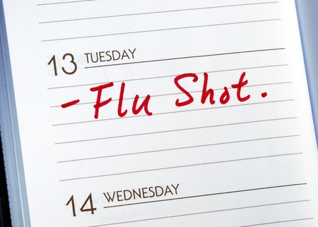 Mark the date on the day planner to have a flu shotの写真素材