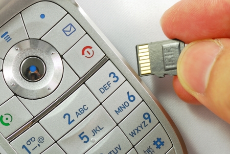 Cellular phone with a memory card concepts of wireless communicationの写真素材