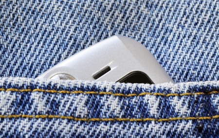 Cellular phone in the jeans pocket concept of communication and styleの写真素材
