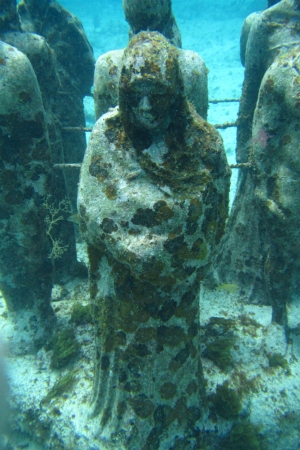 Meditative looking statue under the waters off Cancun Mexico のeditorial素材
