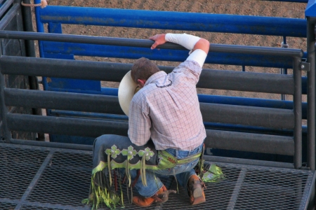 Rodeo cowboy prays before his ride のeditorial素材
