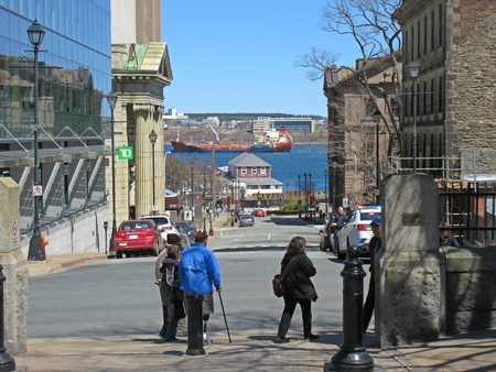 Looking down a Halifax Nova Scotia street with a view of the harbor and a ship in the background.のeditorial素材