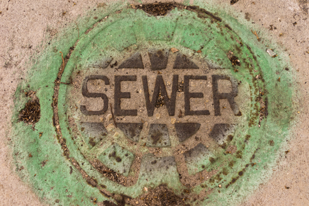 Sewer Cover On The Sidewalkの写真素材