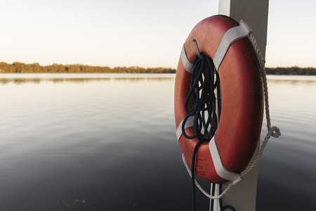 Life Perserver On A Boat Dock Near The Waterの写真素材