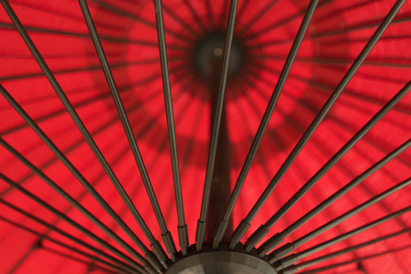 Red Umbrella With Black Metal Poles Outsideの写真素材