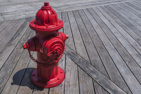 Red Fire Hydrant On A Wooden Deckの写真素材