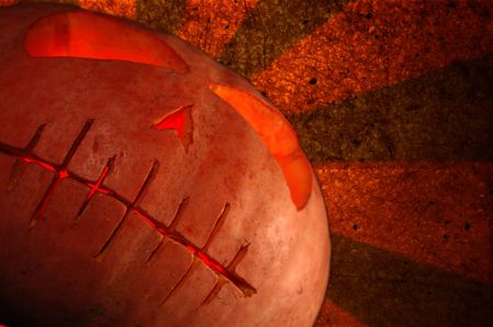 Spooky Halloween pumpkin against grunge backgroundの写真素材
