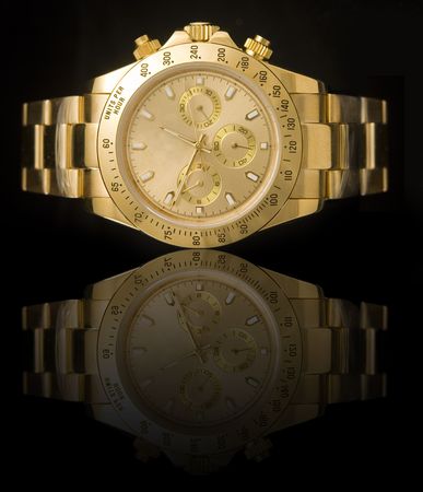 Luxury gold watch isolated on black background with reflectionの写真素材