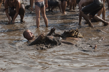 KOSTRZYN, POLAND - AUGUST 02: Przystanek Woodstock Festival, udefined people take the mud bath,...