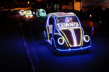 Residents and tourists having fun riding on the iluminated pedal toy cars at night in Yogyakarta Indonesia on June 25 2014のeditorial素材