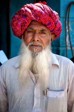 Indian man with white beard in traditional colorful turban portrait Pushkar India. March 6 2013のeditorial素材
