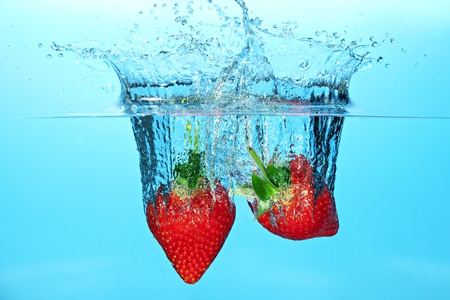 Strawberries Dropped in Water Causing a Splashの写真素材