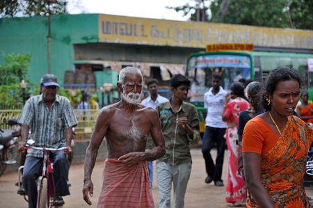 MADURAI, INDIA - 7 NOVEMBER, 2009: Poor indian man nearly without dress walks on the street in Madurai on November 7, 2009. Poverty is the serious problem in the whole India.のeditorial素材
