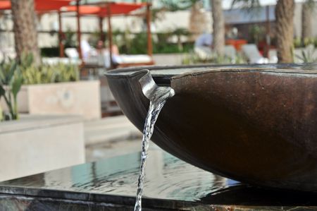 Limpid water flowing out from the can.の写真素材