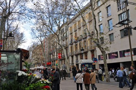 BARCELONA, SPAIN - 29 DECEMBER, 2009:  A group of tourists walk on La Rambla street on December 29,...