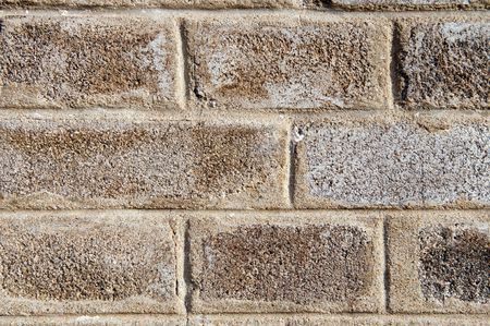 A detailed view of an old grey brick wall.