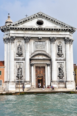 VENICE, ITALY - 30 SEPTEMBER 2009: Tourists walk in the front of  St. Maria del Rosario church on September 30, 2009. It is building in classical style with rococo decoration and is exceptional in preserving its original form and decoration intact.のeditorial素材