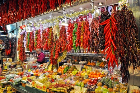BARCELONA, SPAIN - 29 DECEMBER, 2009: Vendors and their goods on La Boqueria market in Barcelona on December 29, 2009. The market is famous for its variety of fresh produces.のeditorial素材