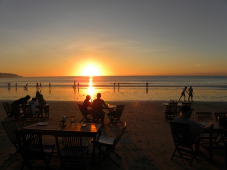 JIMBARAN, BALI - 8 JULY, 2009: Picture of romantic beach restaurant with beautiful sunset sea view on July, 8. Beach restaurants are very popular among tourists.                               のeditorial素材