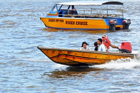 BANDAR SERI BEGAWAN, BRUNEI - MAY 1, 2010: Unidentified passengers travel by water taxi on Brunei River on May 1, 2010 in Bandar Seri Begawan, Brunei. Water taxis are the most common means of negotiating the waterways in city.のeditorial素材