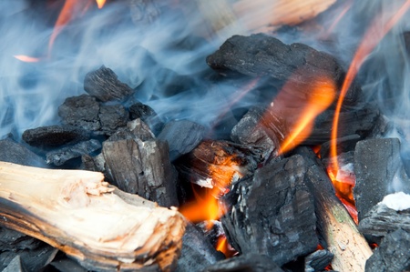 Wood fire with flames, charcoal and embers.の写真素材