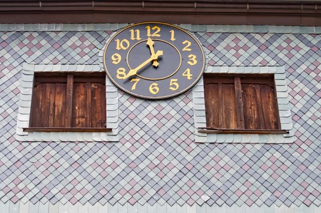 View of medieval clock on the outside of the church in Czermna, Poland.の写真素材