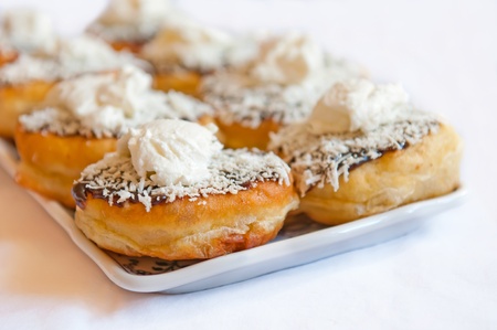 A traditional scone with whipped cream served on a plate.の写真素材