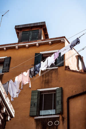 shirts and laundry drying in the streets of veniceの写真素材