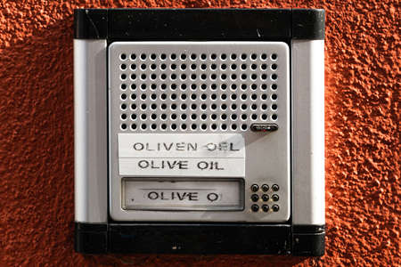 Door bell with sign for olive oil saleの写真素材