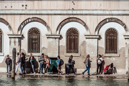 People walking on narrow flooded canal street in Venice during Coronaのeditorial素材
