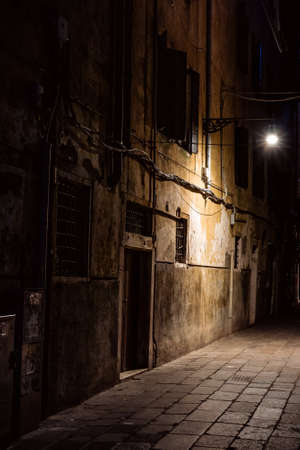 empty street at night in venice illumionated by street lightの写真素材