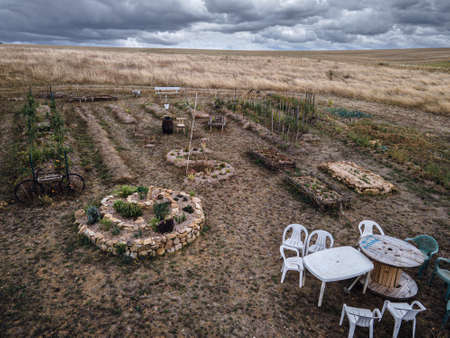 Drone photo of beautiful permaculture garden with seating areaの写真素材