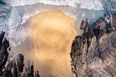 Top down drone photo of lonely beach with surfers in Brittany Franceの写真素材