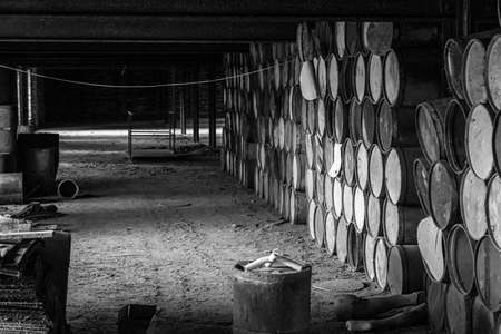 wooden barrels stacked in old abandoned industry buildingの写真素材