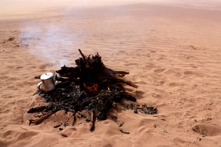 Boiling water in tea kettle on fire in Sahara desertの写真素材