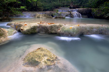 Cascade waterfall in Erawan National Park with big rock in foregroundの写真素材